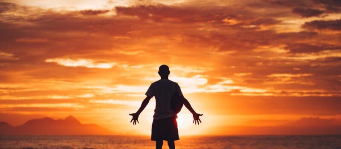 silhouette of man running on beach during sunset